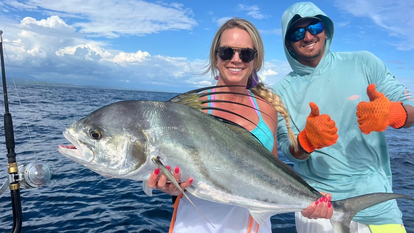 Angler holding a roosterfish with the Tiger Fly crew